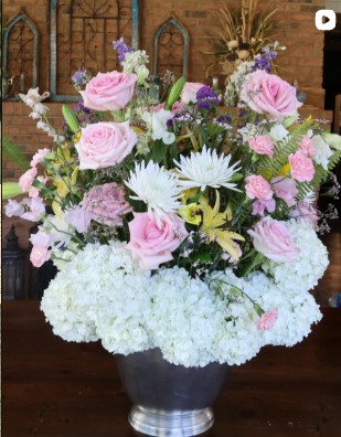 Tall arrangement of white hydrangeas and pink roses for a special occasion