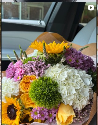 Colorful florist's bouquet with sunflowers, hydrangeas and garden flowers
